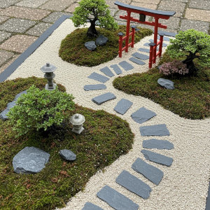 A miniature zen garden with gravel and a Torii gate